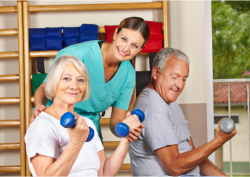 caregiver assisting elderly patients on exercising